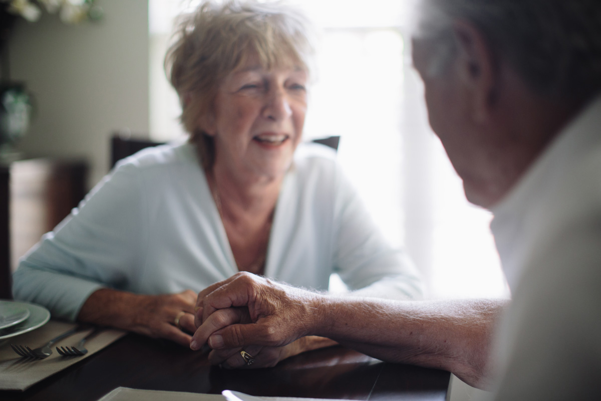 caring senior couple holding hands